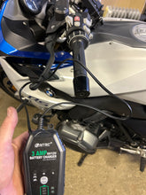 Load image into Gallery viewer, HTRC Motorcycle Battery Charger connected to a BMW R1200RS in the BarMoto Workshop